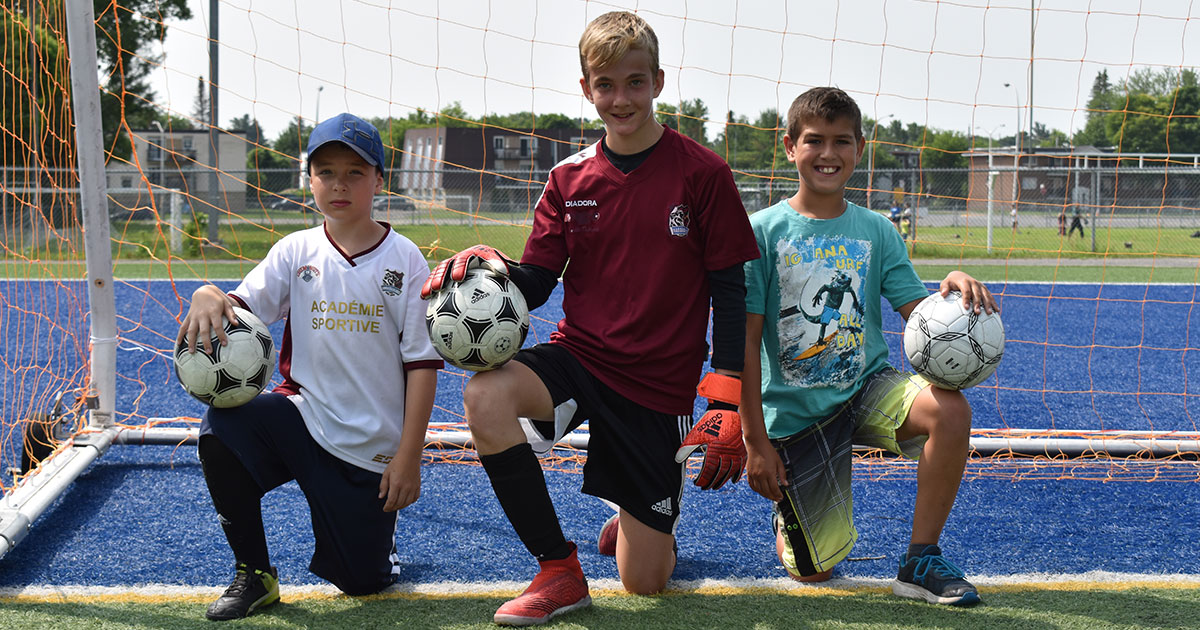 Trois enfants gardiens de but de soccer